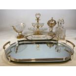 A collection of pressed glass and gilt items to include a tantalus mirrored trays etc.
