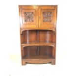 Early 20th century oak book shelves and cupboard. Carved panel doors to interior shelf above two