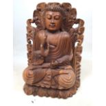 A carved wooden Buddha - finger missing to one hand W:28cm x D:15cm x H:44cm