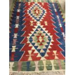 A Kilim rug with two central medallions and fringing to ends W:174cm x H:247cm