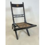 A Late 19th century folding rattan childs or nursing chair with bird illustration in circular