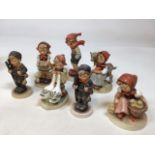 A quantity of Goebel Hummel figures including chimney sweeps, goose girls and others. Tallest 13cm