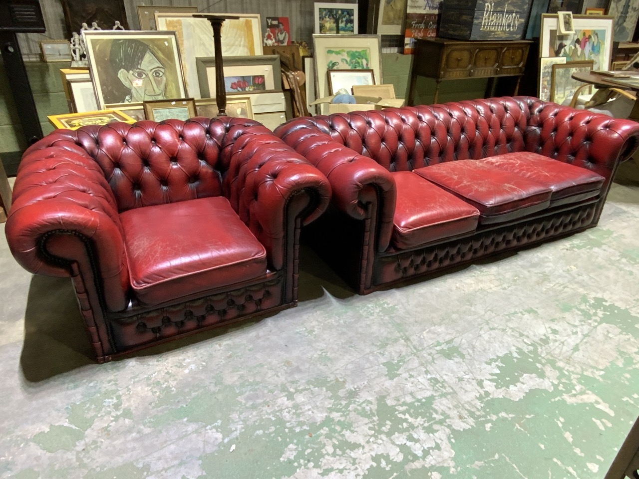 An ox blood red leather button back three seater chesterfield sofa also with an armchair. W:200cm