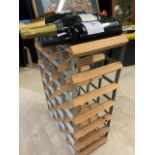 A wine rack with four bottles of alcohol.