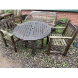 A circular garden table and two chairs. With cushions.