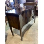 A serpentine fronted sideboard, 20th century, two middle drawers flanked by cupboards. W:141cm x D: