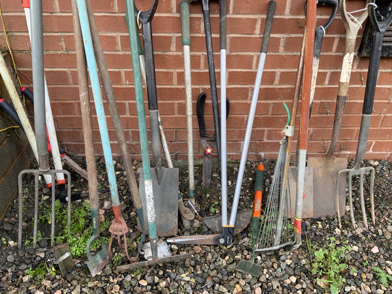 A large quantity of tools, three spades, two forks, various hoes, rakes, sheers etc.