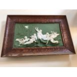 A framed biscuit bas relief plaque W:34cm x H:27cm