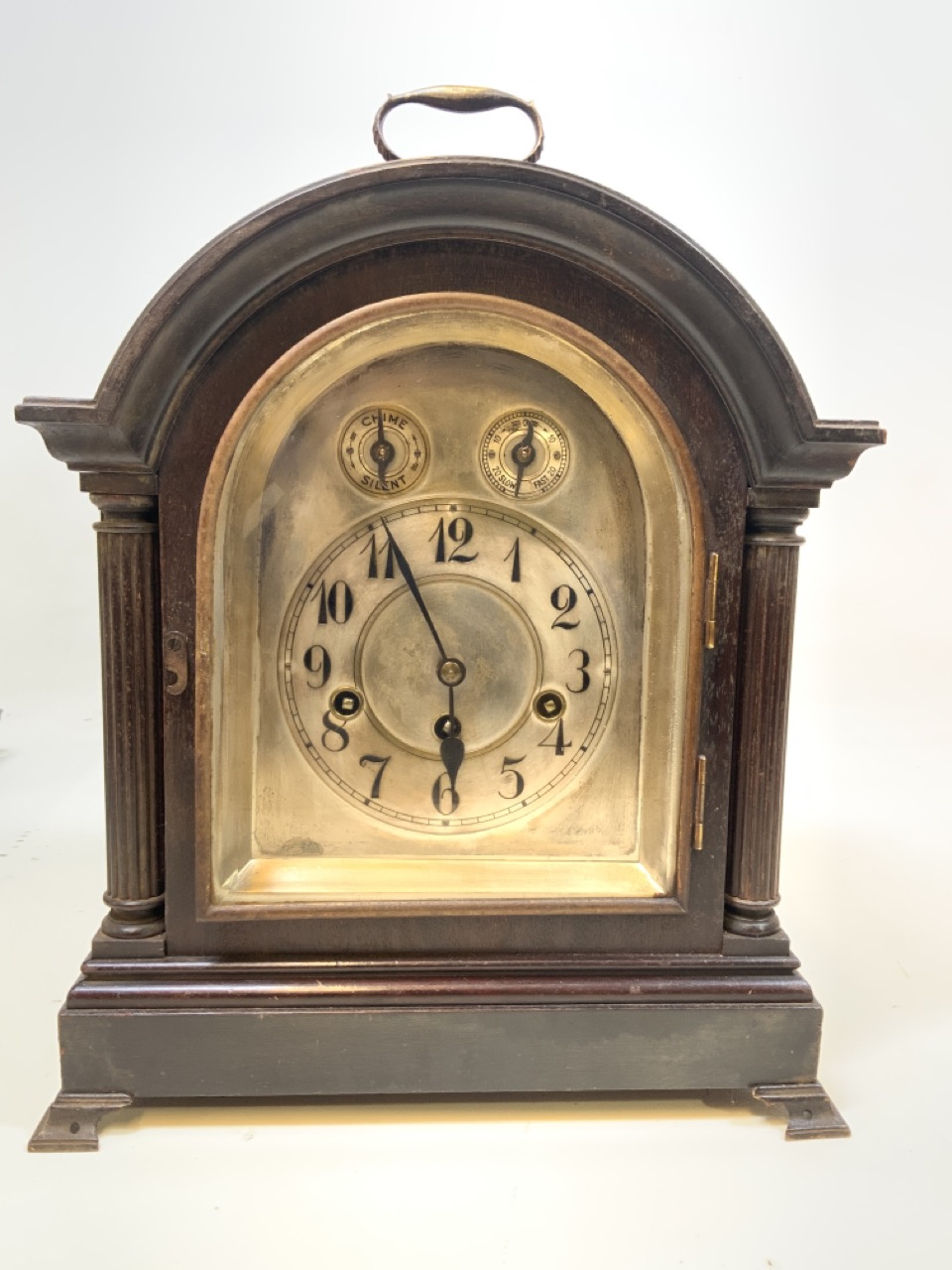 A Large wooden mantle clock marked Junghams Wurttemberg b21 inside. With silvered face.