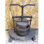 A vintage wooden barrel cider press.