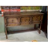 An oak Early to mid 20th century sideboard with three drawers.