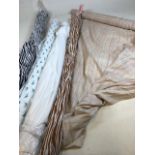 Five small rolls of fabric. A roll of hand woven silk, three rolls of hand printed cotton and a roll