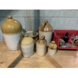 A collection of stoneware flagons, Exeter, Warminster also with some small glass bottles.