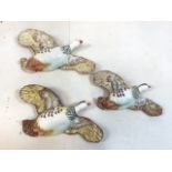 A graduated set of three Beswick Flying Partridge Wall plaques Model 1188, printed and impressed