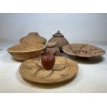 A quantity of baskets also with a primitive style water pot and a carved duck