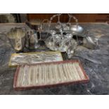 A collection of silver plate, knife rests silver plated and glass, egg cups, silver plated rugs etc