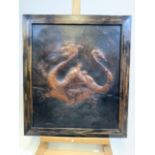 An antique framed leather panel of a dragon. W:38cm x H:45cm