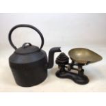 A large, heavy cast iron kettle and a set of scales with weights H:47cm including handle