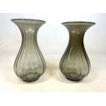 A near pair of smoked glass vases. H:37cm and H:38cm