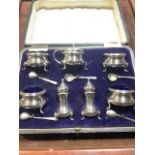 A Hallmarked sterling Birmingham 1912 sliver cruet set with blue glass liners in fitted box. With