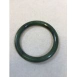 A spinach jade bangle approx 7.5cm diameter