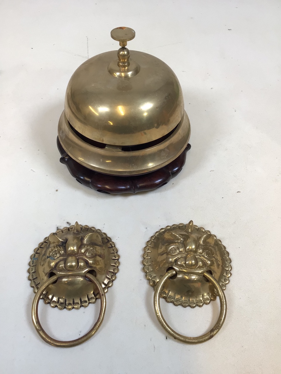 An oriental brass shop bell with two door knockers