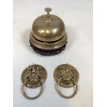 An oriental brass shop bell with two door knockers