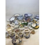 A box of mixed ceramics including a quantity of small jugs, Poole Pottery tea cups