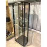 A modern glazed display cabinet with mirrored back and light. Four glass adjustable shelves and