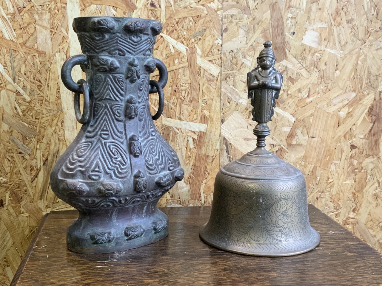 A Large eastern brass bell also woth an eastern heavy metal vase with no base. Height of bell :29cm