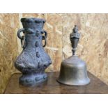 A Large eastern brass bell also woth an eastern heavy metal vase with no base. Height of bell :29cm