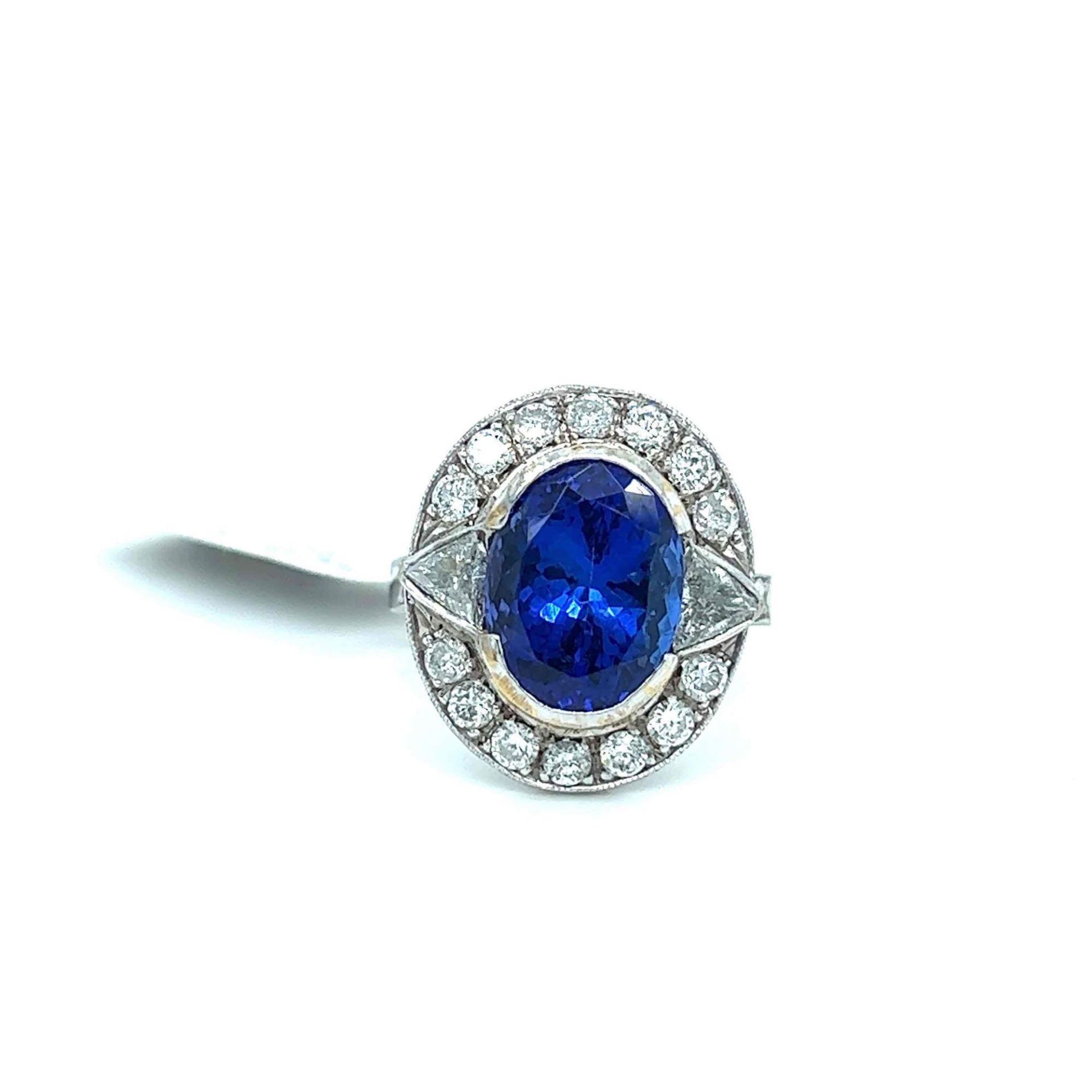 6.60CT TANZANITE AND 1.43CT DIAMOND RING 18K WHITE GOLD