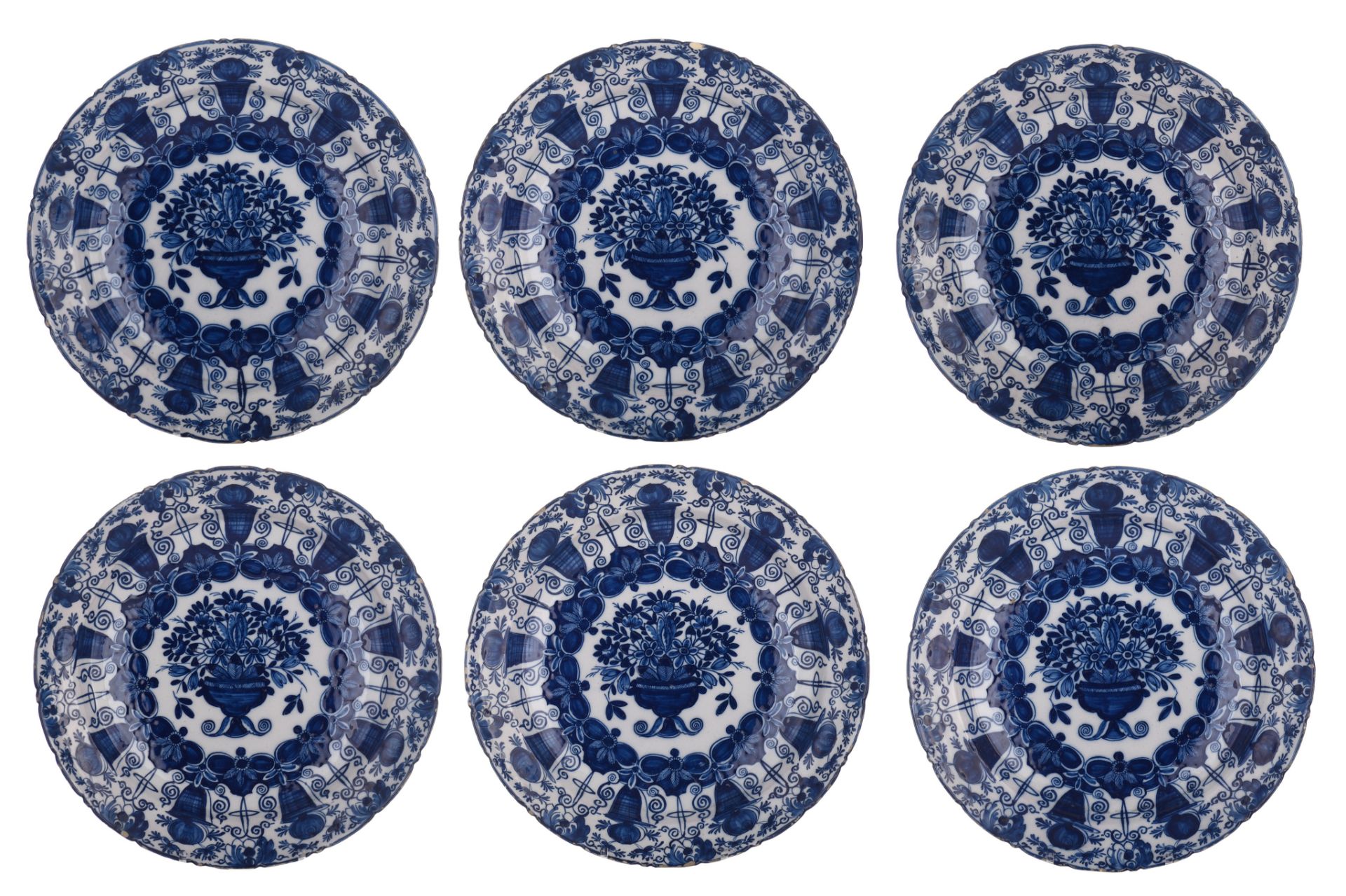 A collection of six Delft blue and white flower basket chargers, marked 'De Klauw', 18thC, ø 35 cm
