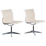 A pair of Eames 'EA105' swivel chairs, and white 'Skai' leather, Herman Miller edition, H 84 - W 53