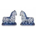 A pair of Dutch Delft blue and white figures of recumbent circus horses, 18th/19thC, H 12,5 - 13 cm