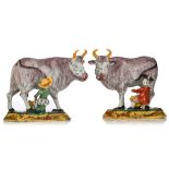 A large pair of Delft polychrome models of cows with milkers, marked Johannes Van Duyn, 18thC, H 18,