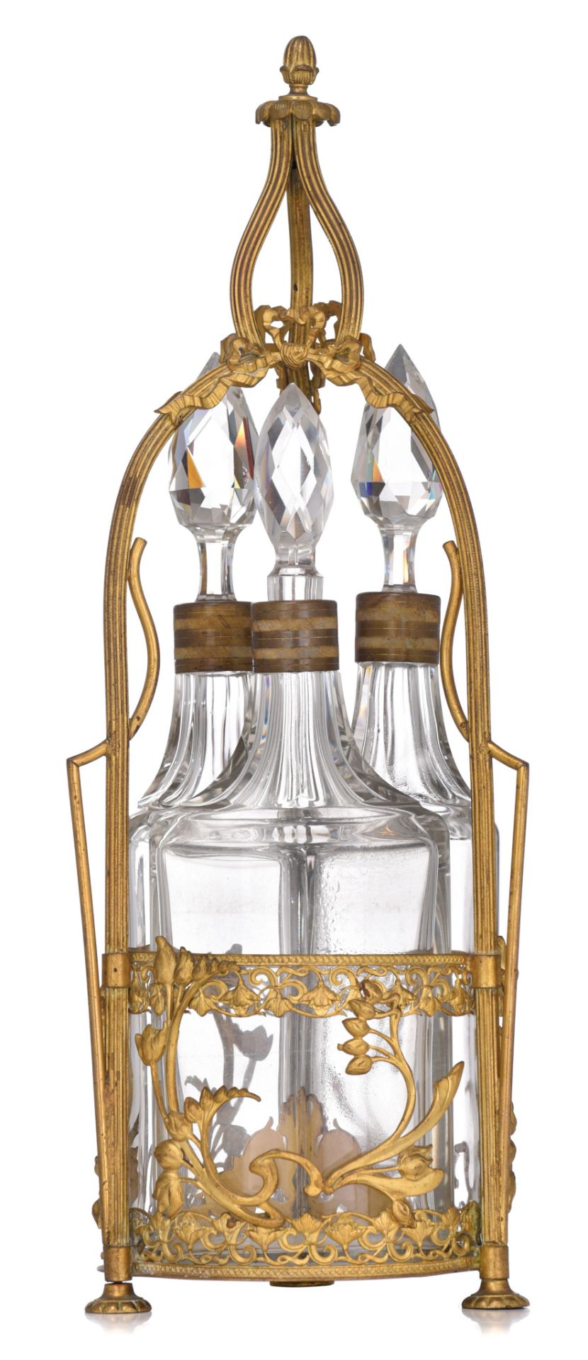 A fine Art Nouveau gilt brass cruet set with three cut glass carafes, H 43,5 cm