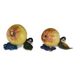 A pair of Dutch Delft polychrome 'trompe l'oeil' models of apples, 18thC, H 7 - 7,5 - W 11 - 11,5 cm