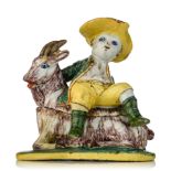 A charming Delft butter tub with a boy sitting on a goat, marked 'De Drie Posteleyne Astonne', 18thC