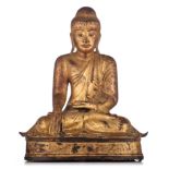 A Burmese Mandalay gilt-bronze seated Buddha, 19thC, H 48,5 - W 40,5 cm