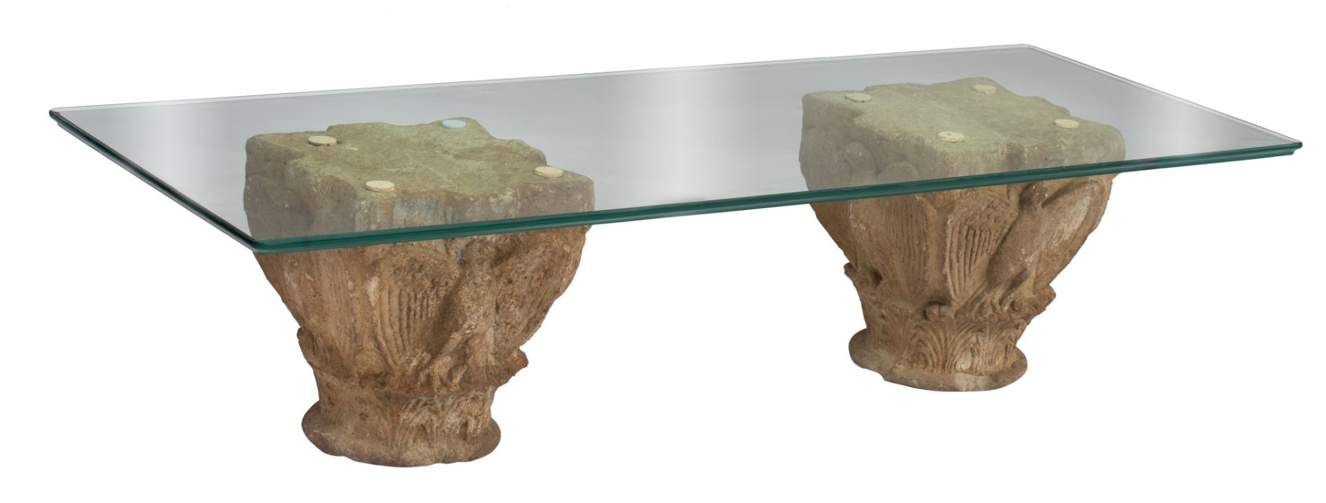 A coffee table formed by two Romanesque capitals, glass top, H 36 - W 149,5 - D 59,5 cm