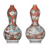 (BIDDING ONLY ON CARLOBONTE.BE) A pair of Japanese Kutani coral-red grlound double-groud vases, Meij
