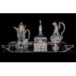Two 19thC carafes and a 20thC silver-mounted carafe on a silver-plated tray, H 27,5 - 30 cm