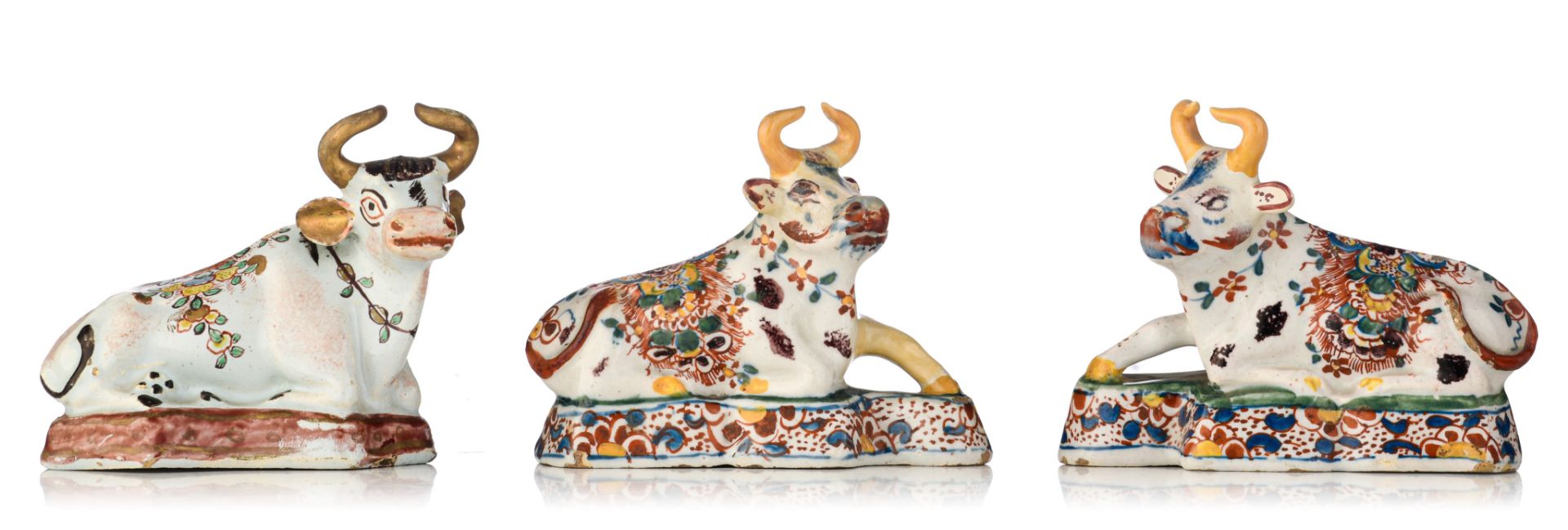 A pair of and a ditto Dutch Delft polychrome figure of a recumbent cow, 18thC, H 8-9 cm