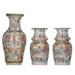 A pair of Chinese Canton famille rose vases and a ditto baluster vase, 19thC, H 34 - 47 cm