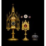 A Gothic Revival gilt brass tower and matching solar monstrance, three relic holders, and a silver M