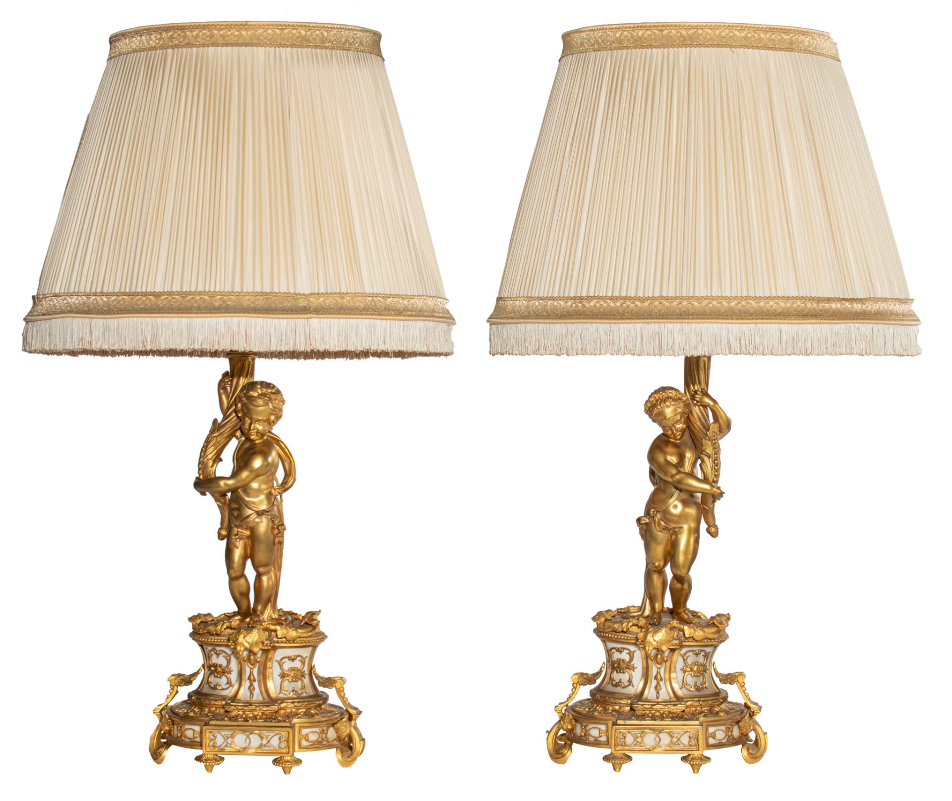 A pair of Neoclassical gilt bronze figural lamps on stands, and a matching pair of sculptures of put