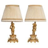 A pair of Neoclassical gilt bronze figural lamps on stands, and a matching pair of sculptures of put