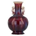 A Chinese flambe-glazed bottle vase, paired with archaistic dragon handles, H 35 cm