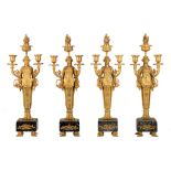 A set of four Empire style caryatid candelabras, gilt bronze on a vert de mer marble base, H 51,5 cm
